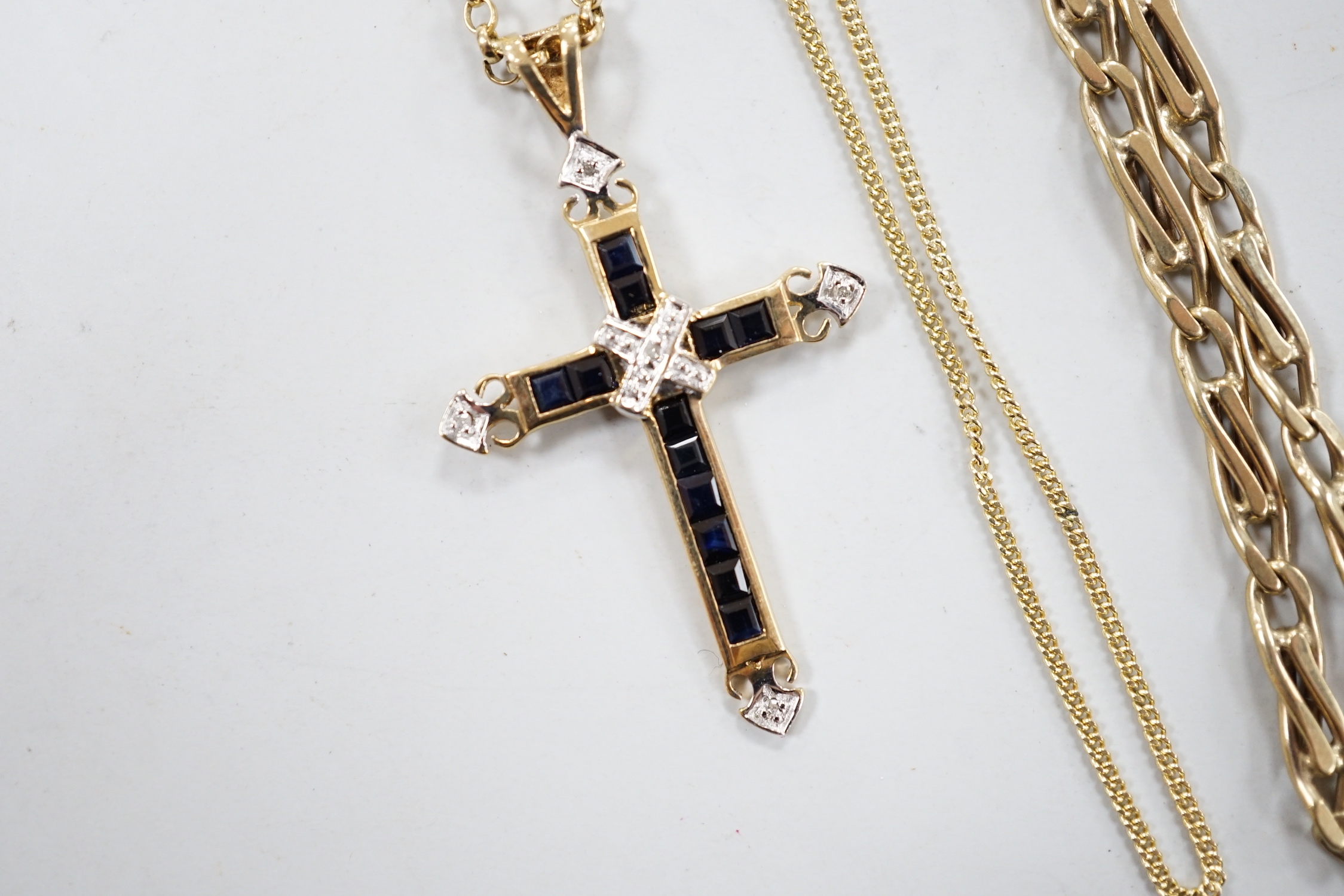 A modern 9ct gold, sapphire and diamond cluster set cross pendant, 33mm, on a 9ct gold chain and two other 9ct gold chains, gross weight 17.5 grams.